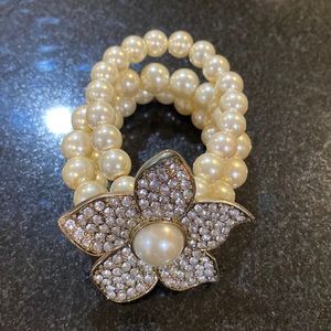 Stacked pearl bracelet with flower embellishment